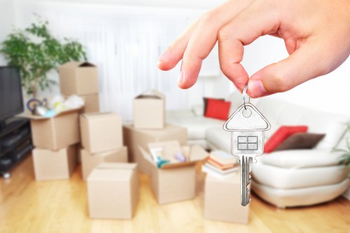 Professional movers handling boxes and office equipment in Hackney