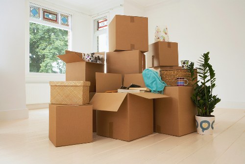 Loading household boxes and furniture into a van in Hackney